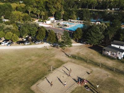 Aerial view of a beach volleyball court and pool at a campsite.