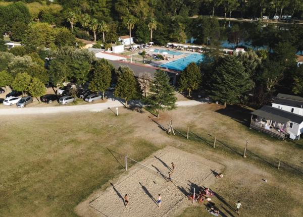 Aerial view of a beach volleyball court and pool at a campsite.